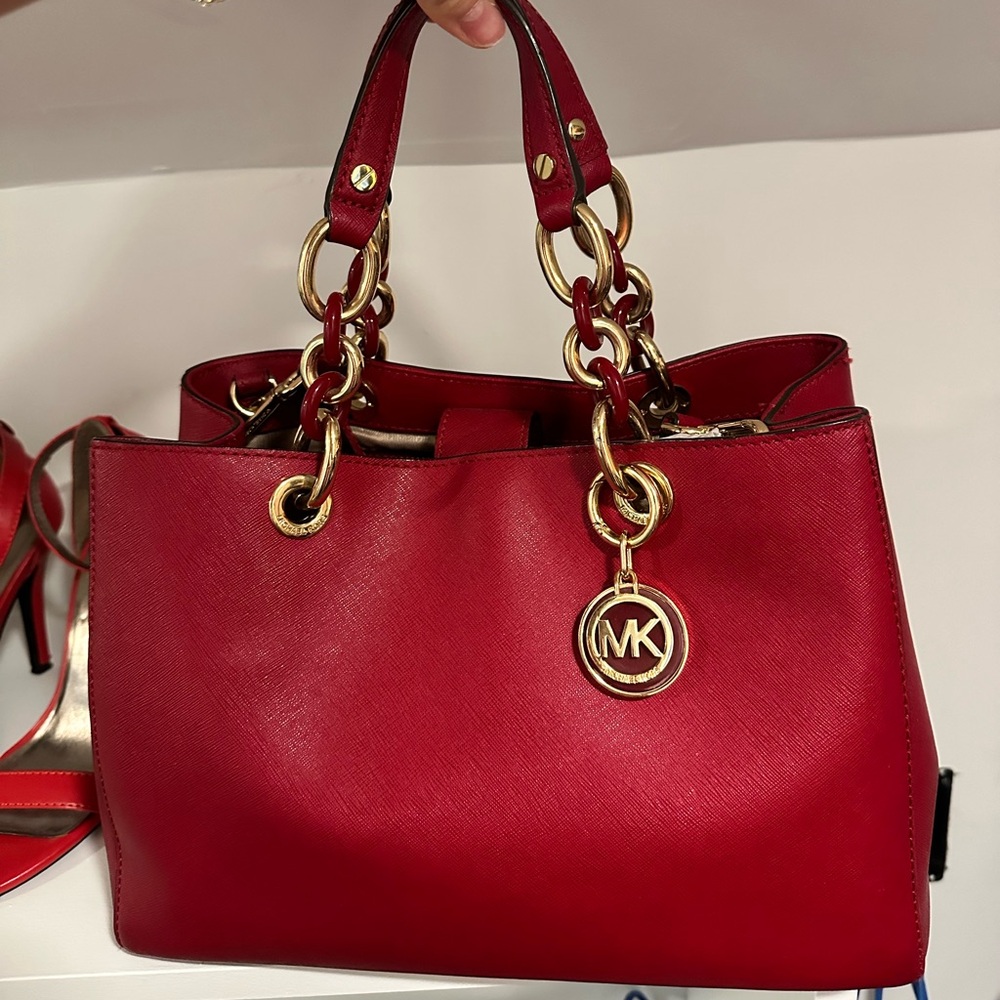 Red Michael Kors bag. Long strap attached. Barely used